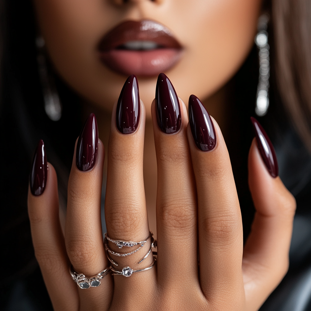 Photo of woman with new almond-shaped merlot nails.