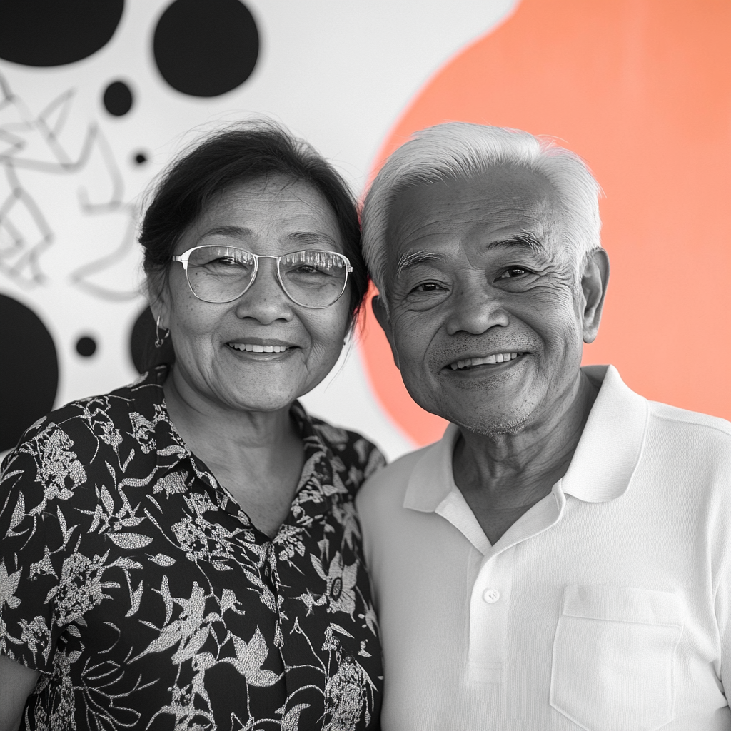 Senior Filipino couple in black and white portrait.