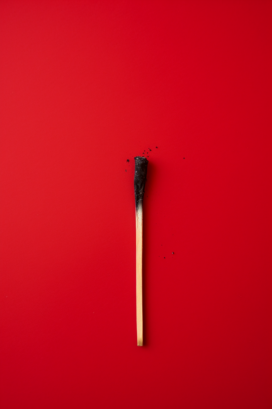 Matchstick on red background