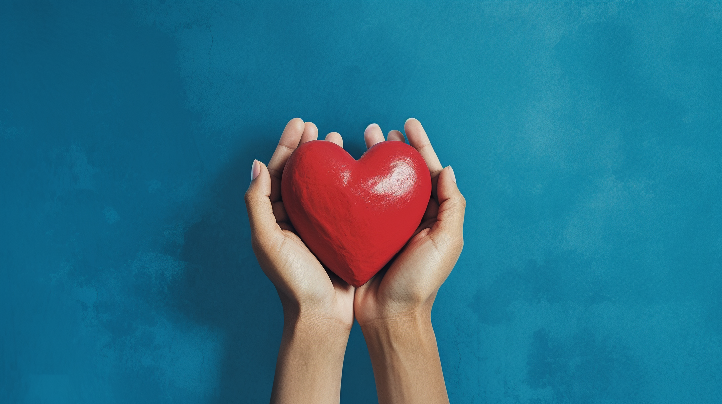 Hands holding heart on blue background