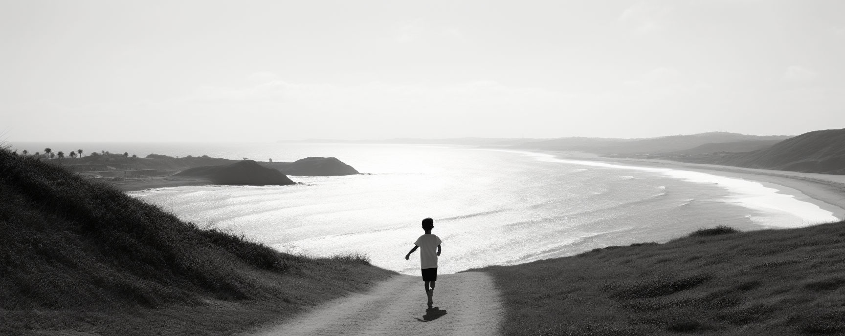 Child running up hill on beach