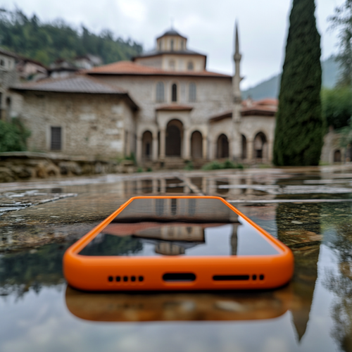 An Orange Smartphone in Front of Sürmene Monastery