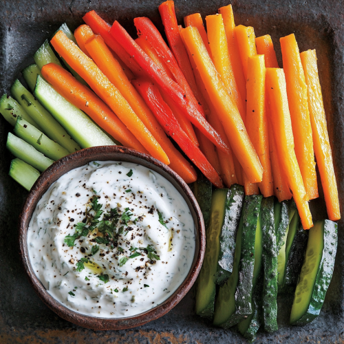 Colorful veggie sticks and creamy yogurt dip display Colorful veggie sticks and creamy yogurt dip display