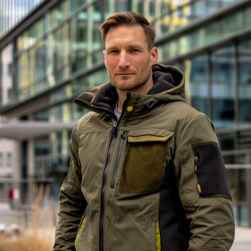 Confident man in green jacket in urban setting.