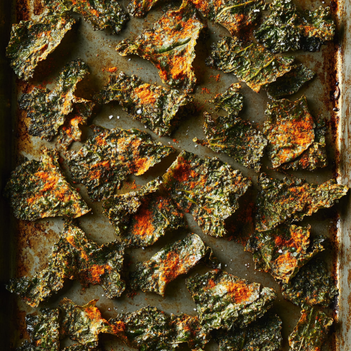 Crispy kale chips seasoned with paprika on tray