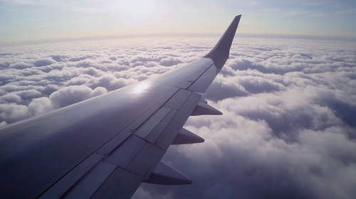 Dark US Fighter Jet Wing in Clouds