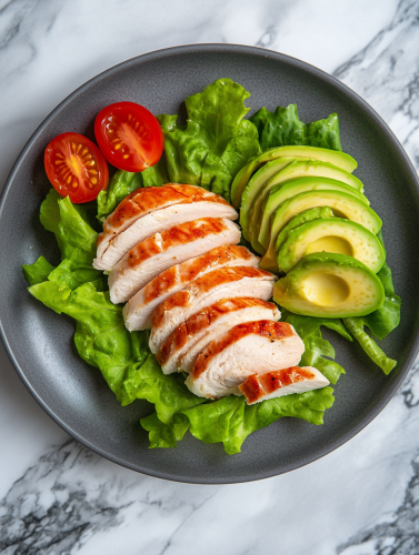Delicious turkey plate on marble table with avocado.