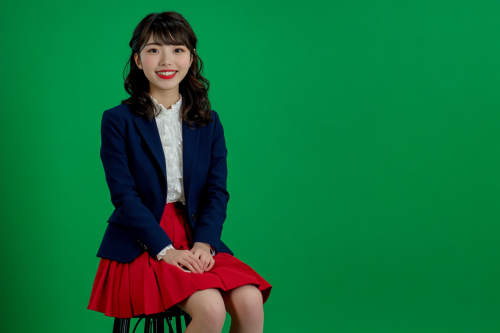 Japanese woman in blue and red outfit smiling happily.