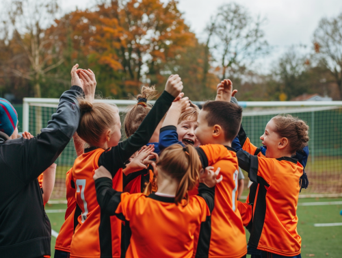 Joyful young football team celebrating goal together
