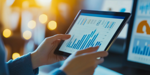 Person carefully tracking expenses on tablet in modern workspace. Person carefully tracking expenses on tablet in modern workspace.