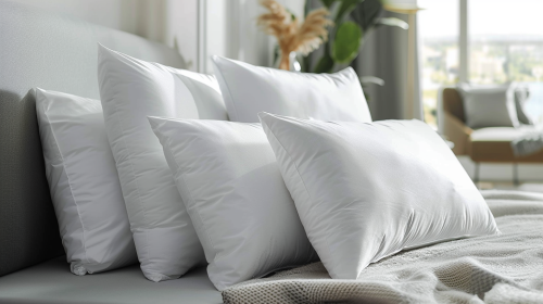 Soft white pillows on modern bed