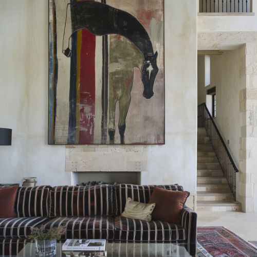 Striped couch, velvet cushions, modern horse painting, earthy colors.
