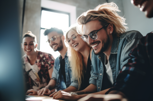Young office workers laughing at laptop screen
