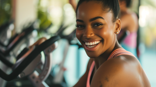 Black woman smiling in spinning class