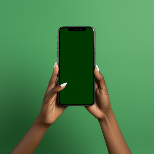 Black woman's hand holding phone with green screen