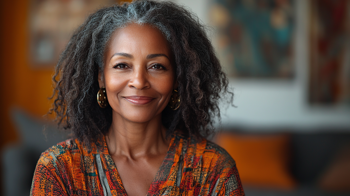 55 year old Black woman smiling with tablet phone.