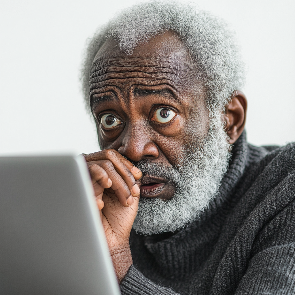 A Worried Old Man Looking at Laptop