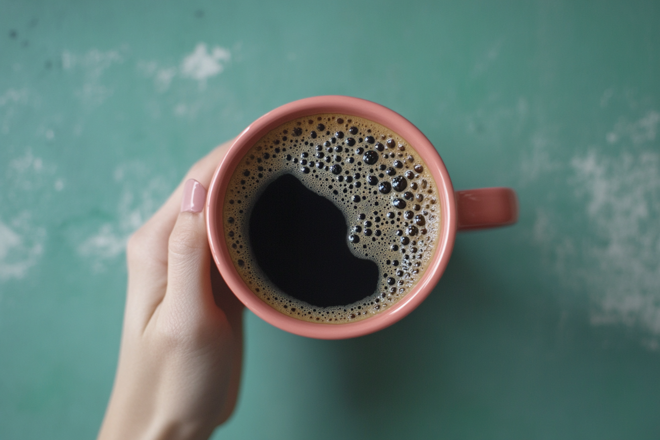 A happy coffee mug on a green table