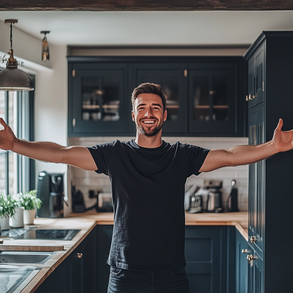 British man in renovated kitchen looking happy. Full body.