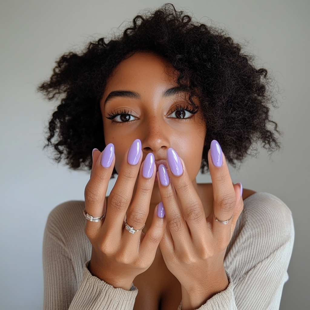 Candid photo of woman with new lilac nails.