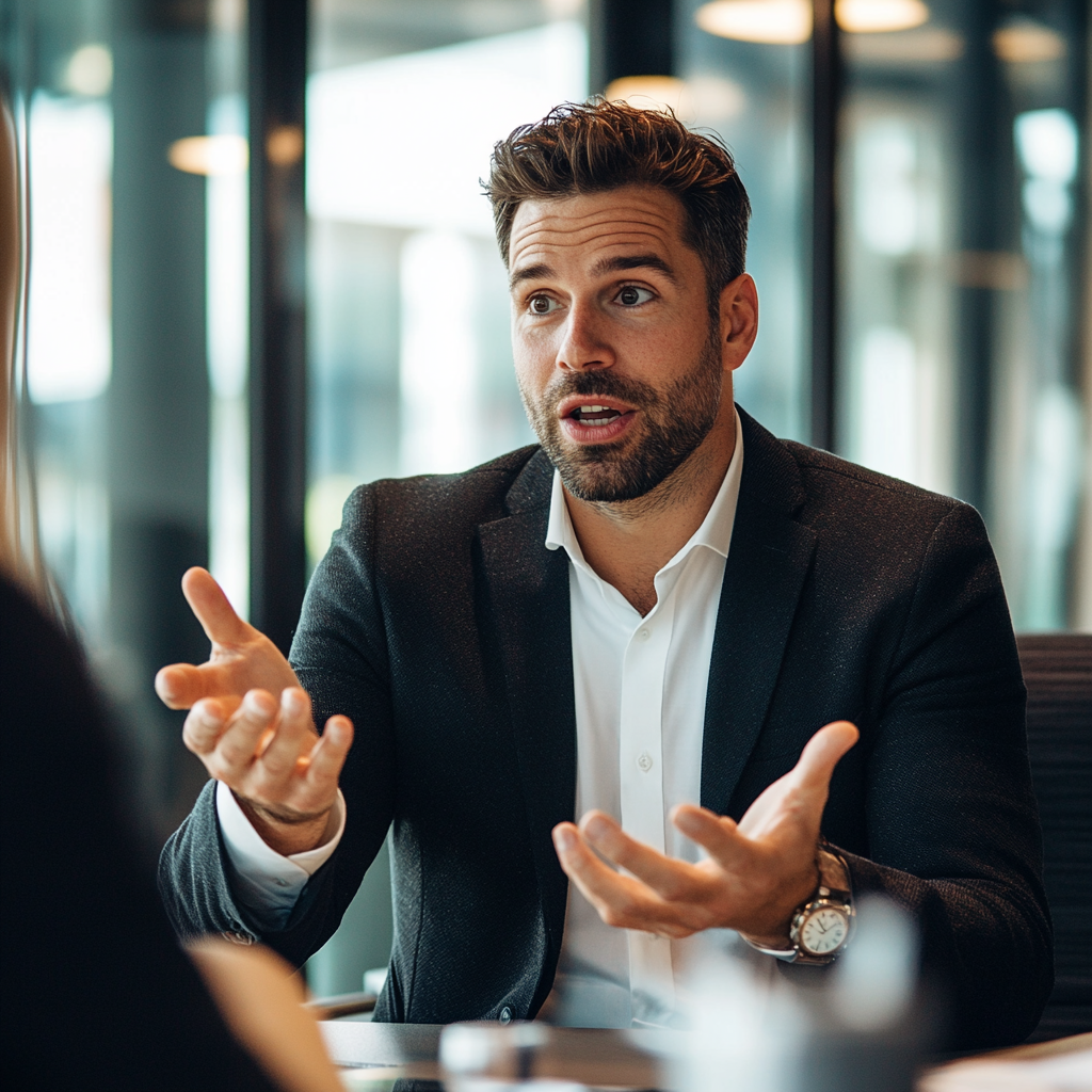 Confident salesman in suit presenting product in bright office.