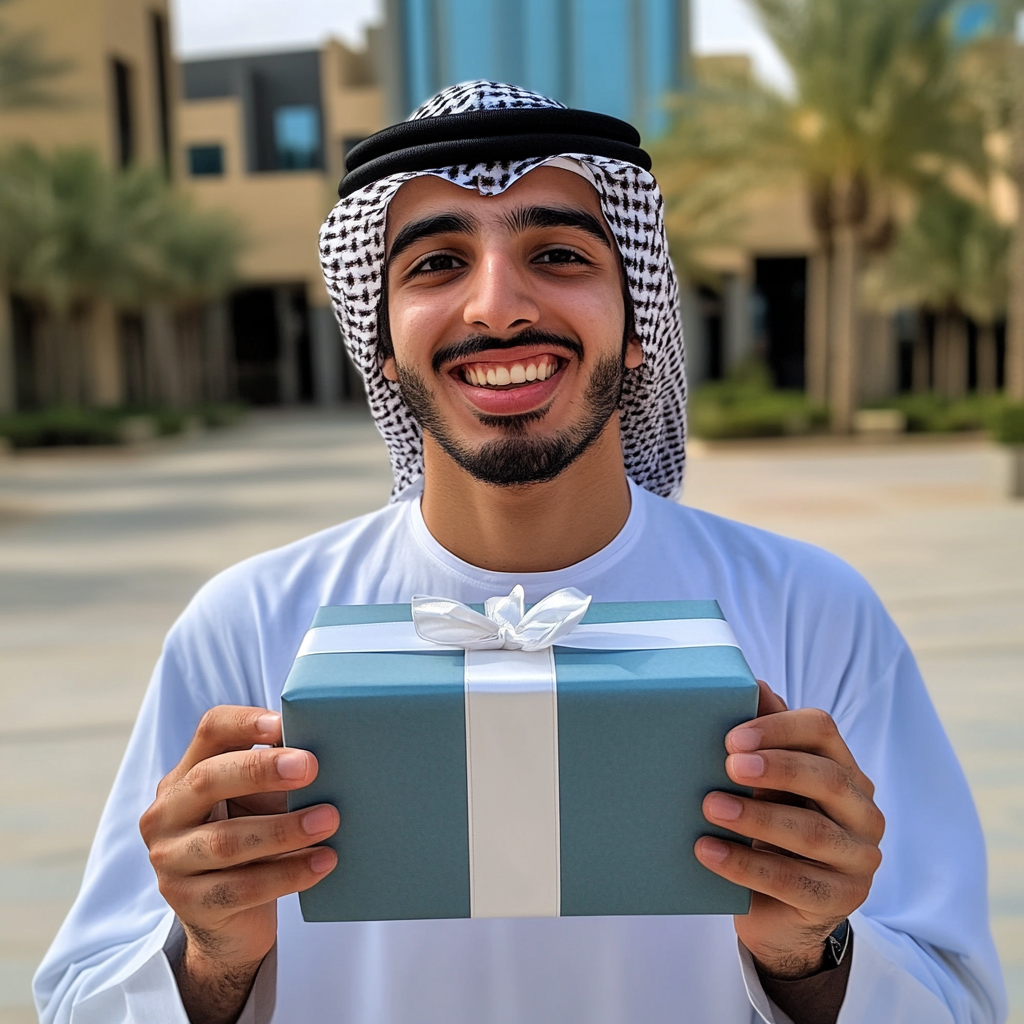 Excited Arab young man holding mystery gift happily.