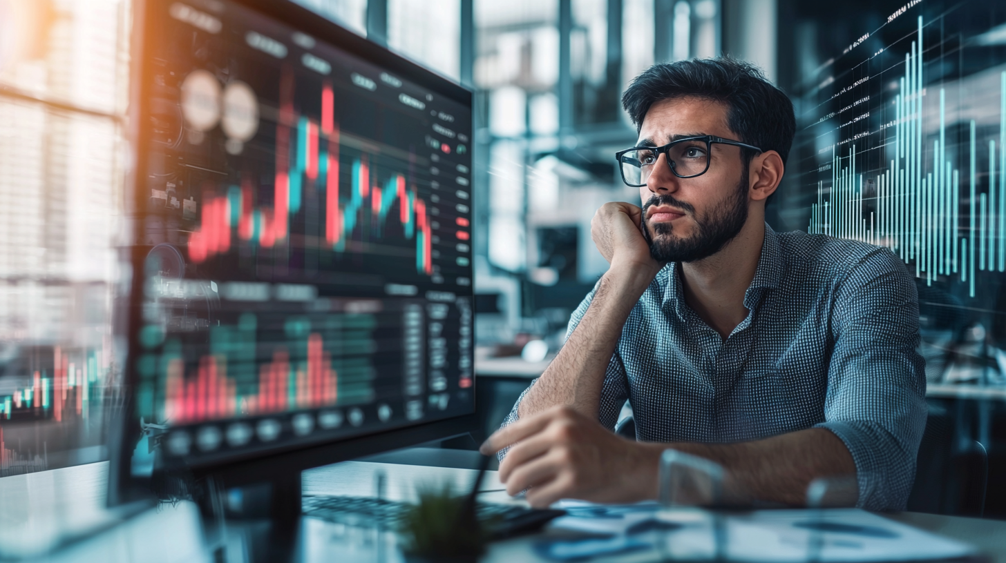 Financial Executive Analyzing Data on Computer Screen.