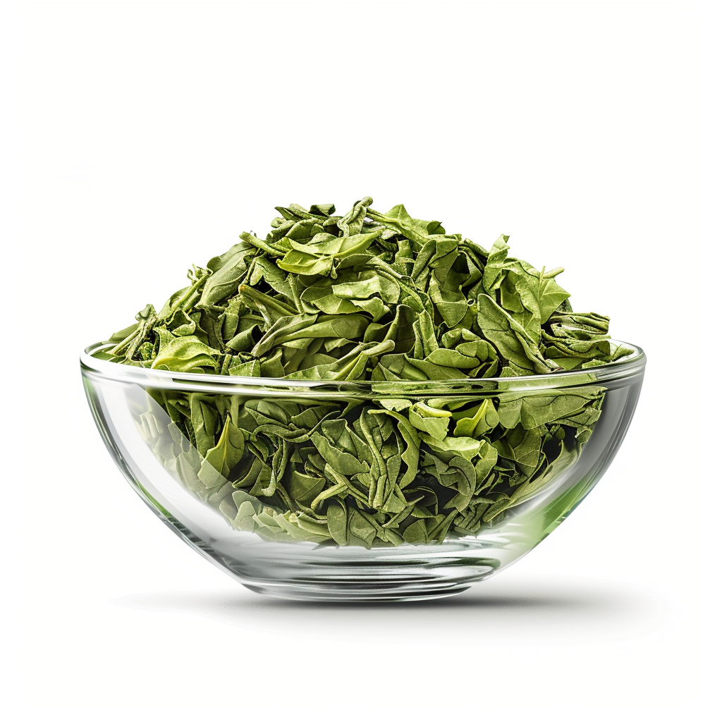 Green tea leaves in glass bowl on white background