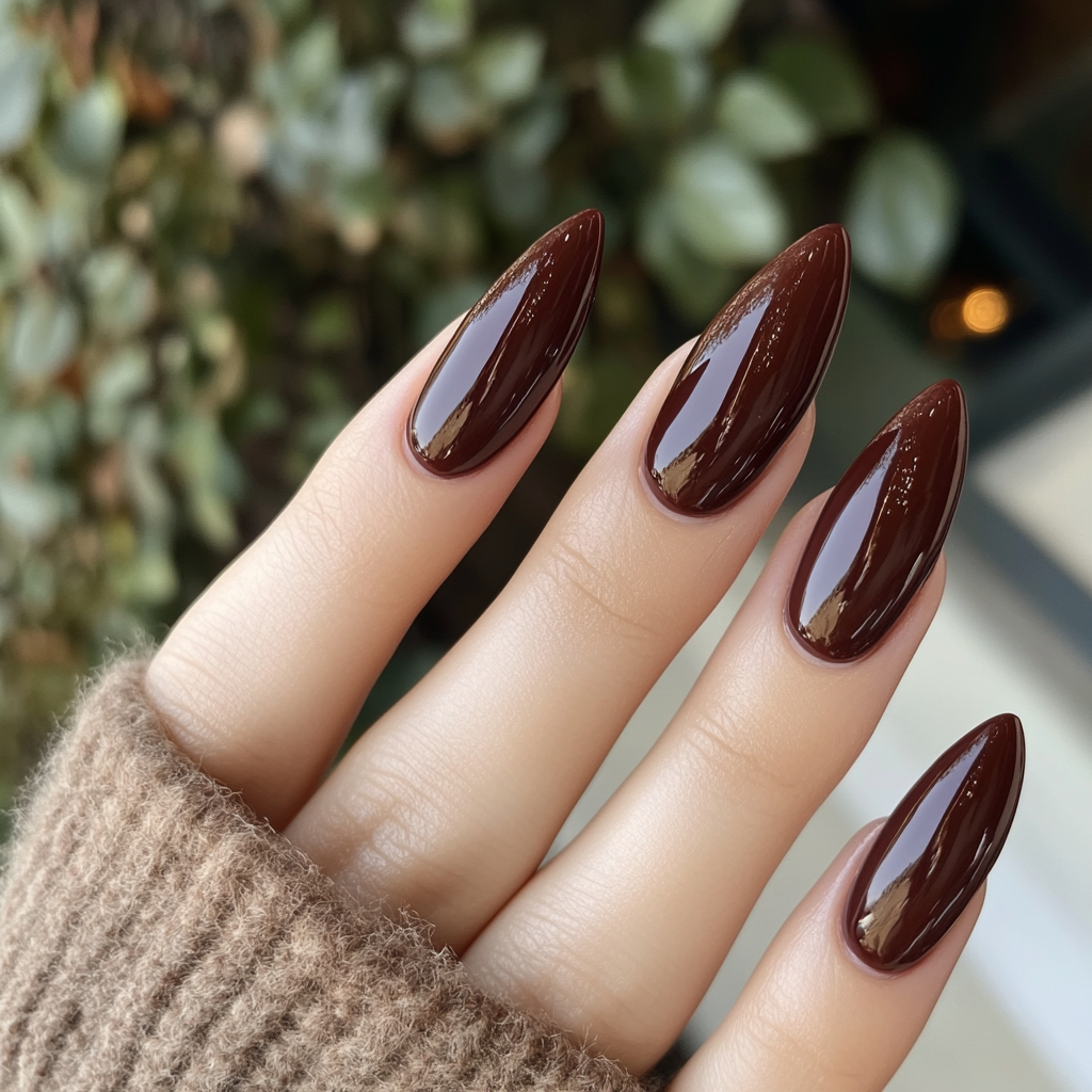 Photo of woman with new almond-shaped merlot nails.