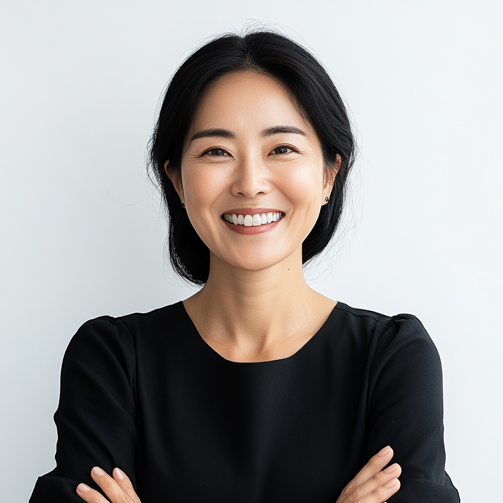 Trendy Korean woman in her 50s smiling confidently.