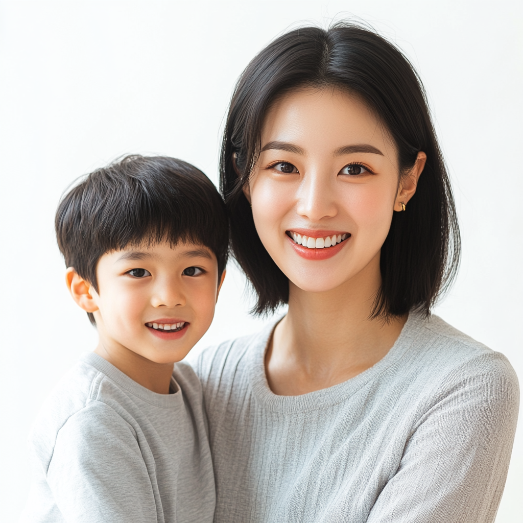 Young Korean woman, confident smile, white background, with son.