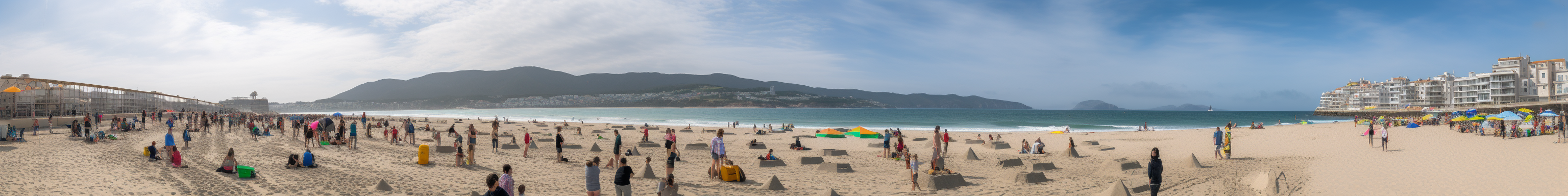 Parents and kids building sand castles on the beach