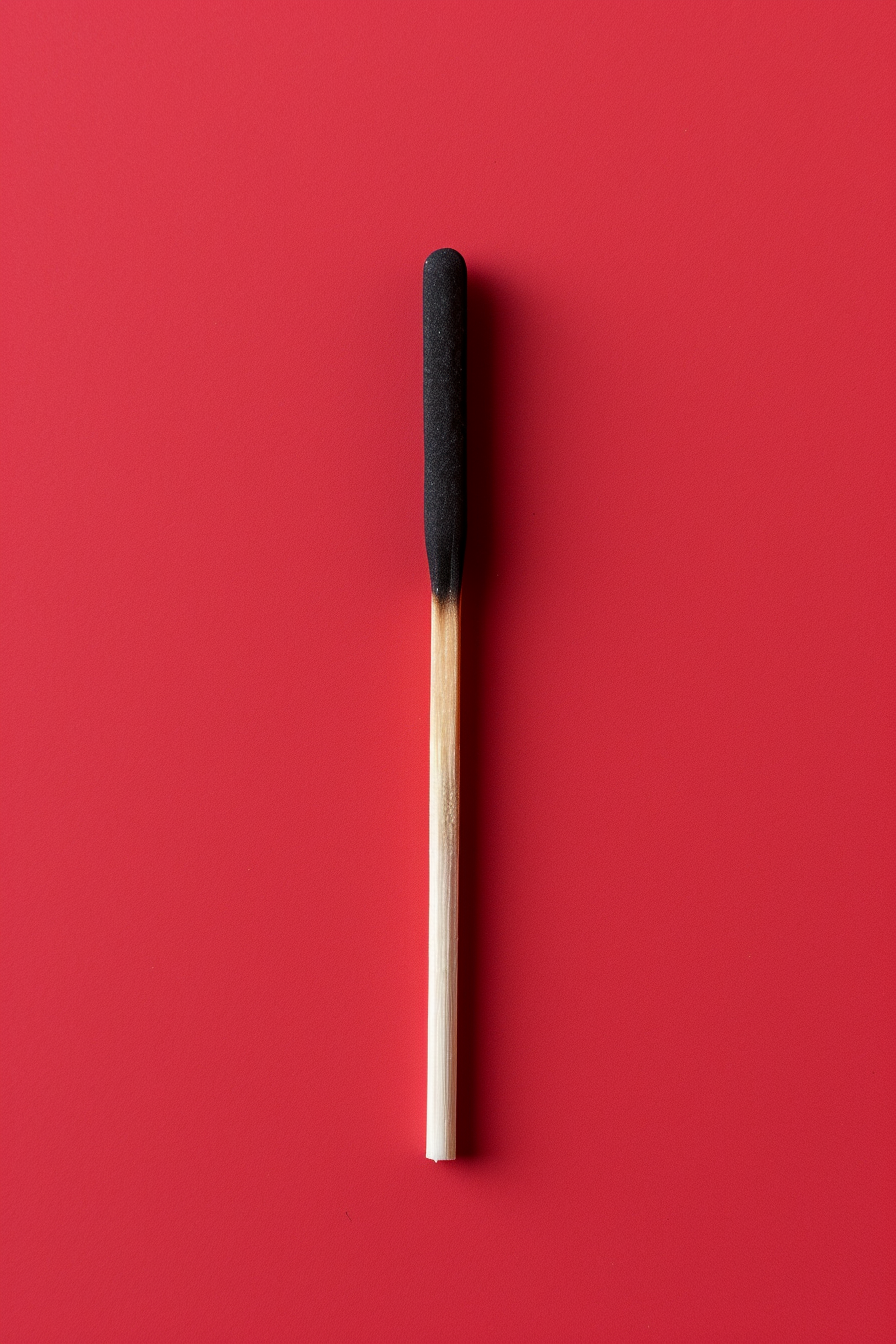 Matchstick on red background