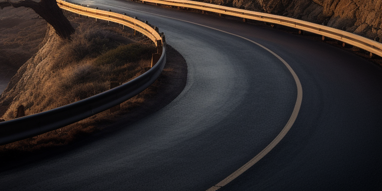 Coastal road with crashing waves at sunrise