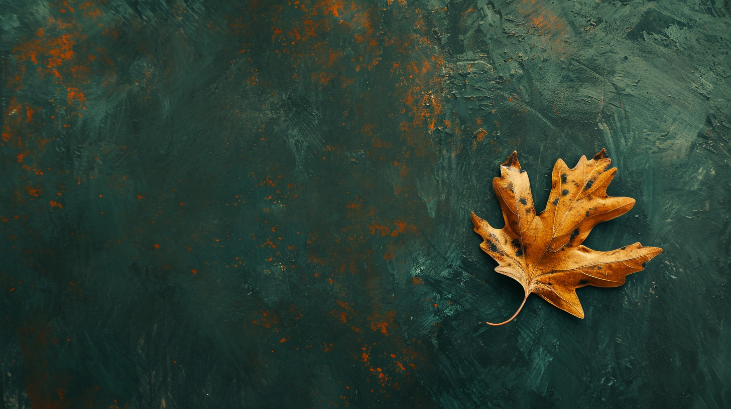 Golden oak leaf falling on dark green background